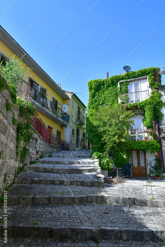 Fototapeta premium A narrow street with old houses in Pietrelcina, a medieval town in Campania, Italy.