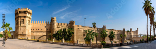 A large castle like building with towers historic royal landmark abstract on blue sky background
 photo