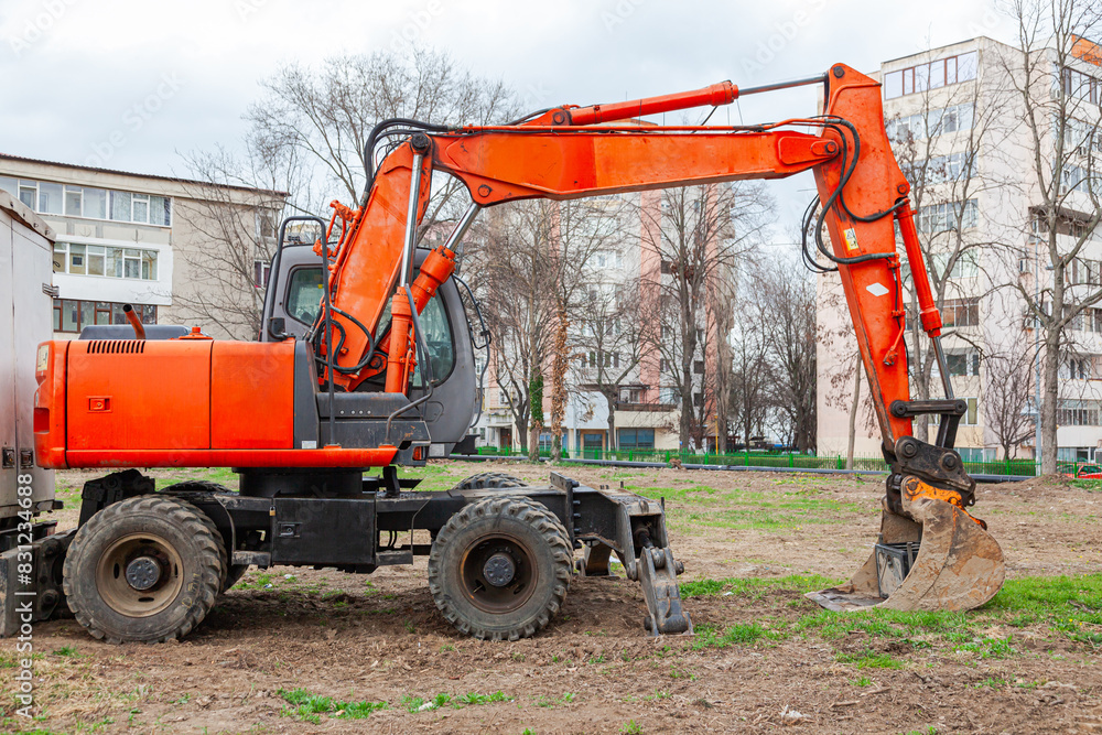 Fototapeta premium A wheeled excavator stands on the construction site.