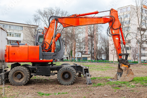 A wheeled excavator stands on the construction site.