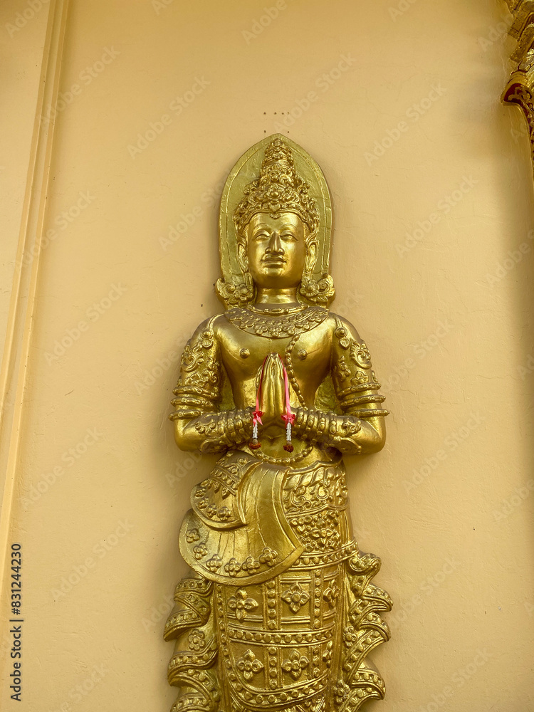 Golden Thai Buddhist Idol statue in Chiang Mai Thailand symbolizing worship at tourist temple.