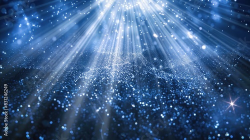 Enchanting blue glitter particles falling gracefully in delicate light rays, creating a mesmerizing loop effect photo