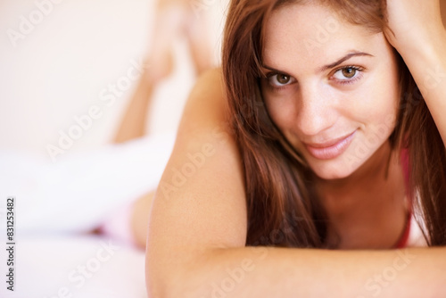 Portrait, bed and woman with peace, relax and happiness with weekend break, morning and cheerful. Face, person and girl in house, bedroom and calm with hospitality, playful and holiday with hotel © peopleimages.com