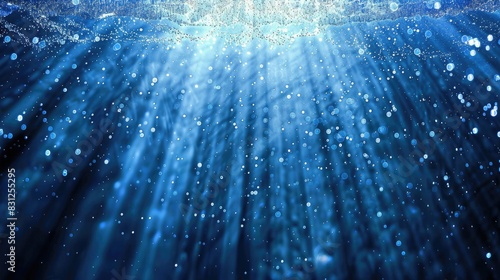 Continuous loop of enchanting blue glitter particles descending in soft, delicate light rays