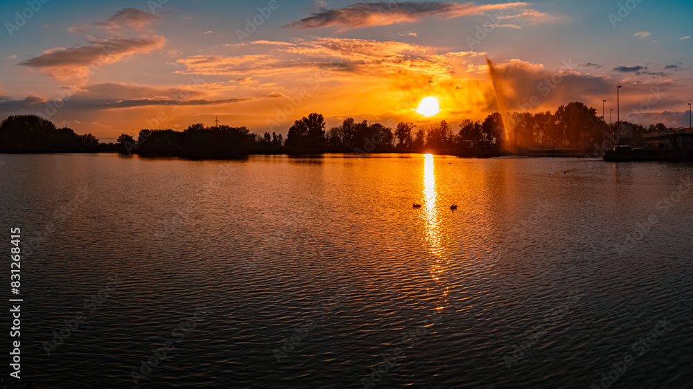 Fototapeta premium Sunset with reflections near Plattling, Isar, Bavaria, Germany