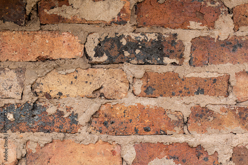 texture of old brick wall fired with cracks photo