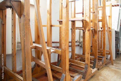 art education  hobby  training in group class concept . Wooden easels   in row . Row of drawing stands.