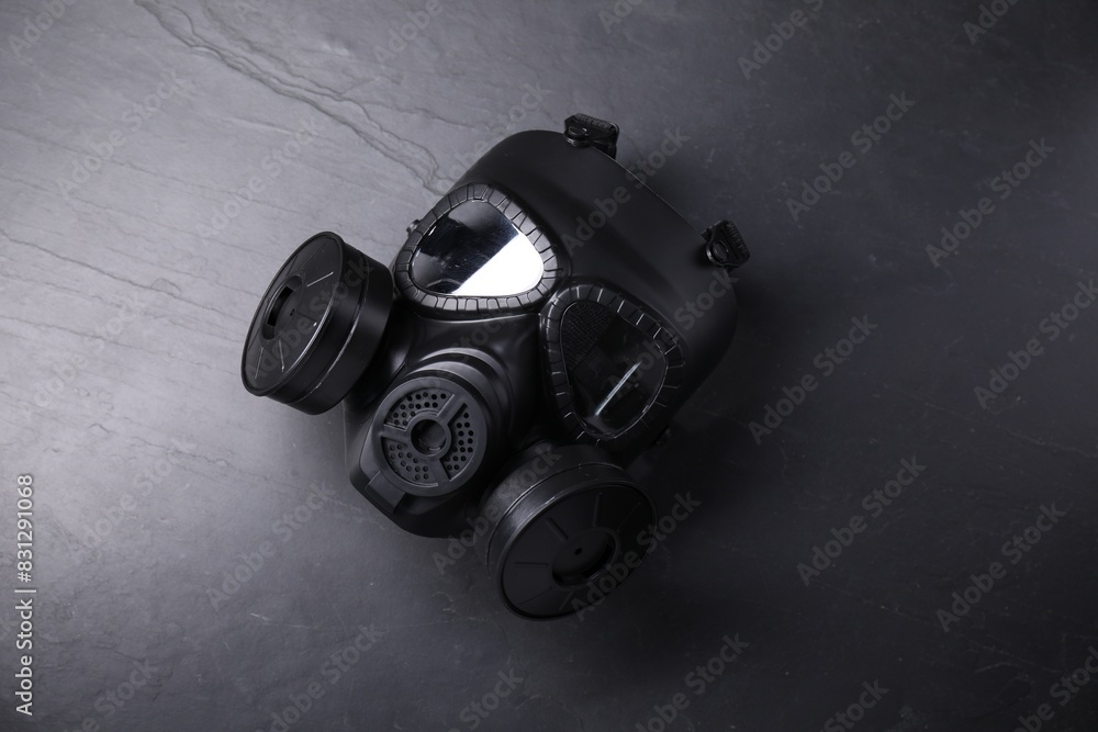 One gas mask on grey textured background, top view One gas mask on grey textured background, top view