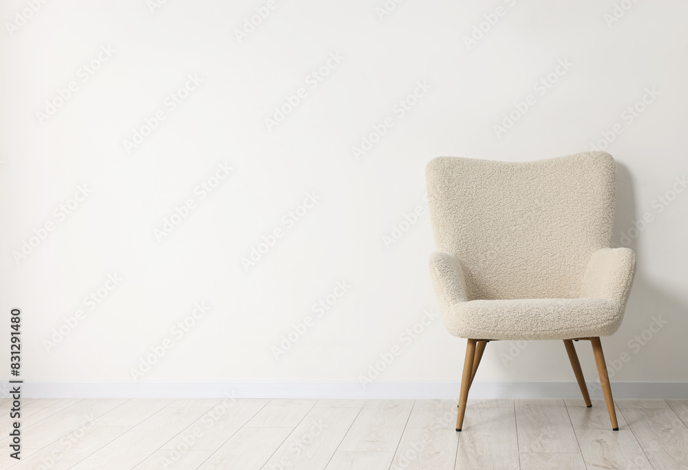 Fototapeta premium Comfortable armchair near white wall in room, space for text