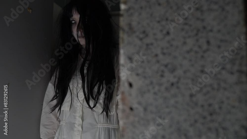 A ghostly woman roams the decayed halls of an abandoned house, her pale figure flickering in the dim moonlight, trapped between worlds, forever searching for vengeance on a cold Halloween night