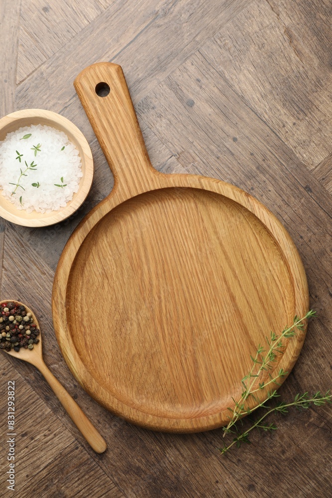 Cutting board and different spices on wooden table, flat lay Cutting board and different spices on wooden table, flat lay