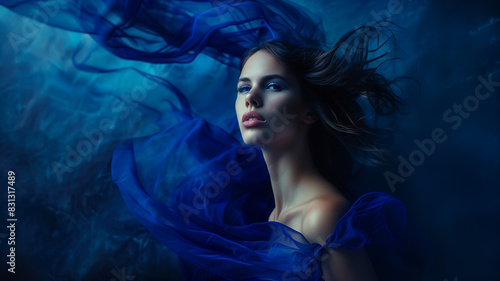 portrait of a woman in a celestial blue gown  her expression imbued with quiet strength and determination  set against a backdrop of deep indigo