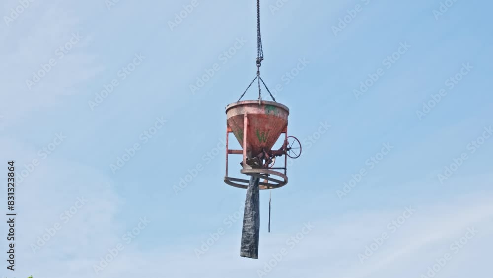 Concrete Funnel Skip for Aiming and Placing Concrete Lifted with Crane over Construction Site Concrete Funnel Skip for Aiming and Placing Concrete Lifted with Crane over Construction Site