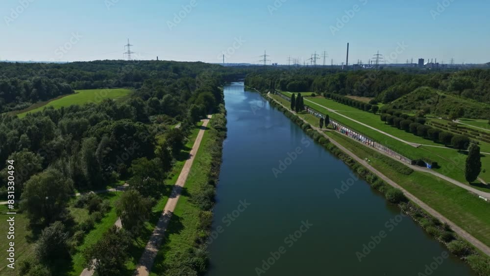 Aerial drone view of the Rhein-Herne Canal in Gelsenkirchen, Germany. The Rhine Herne kanal is a transportation canal in the Ruhr area of North Rhine-Westphalia, Germany, featuring five canal locks. Aerial drone view of the Rhein-Herne Canal in Gelsenkirchen, Germany. The Rhine Herne kanal is a transportation canal in the Ruhr area of North Rhine-Westphalia, Germany, featuring five canal locks.