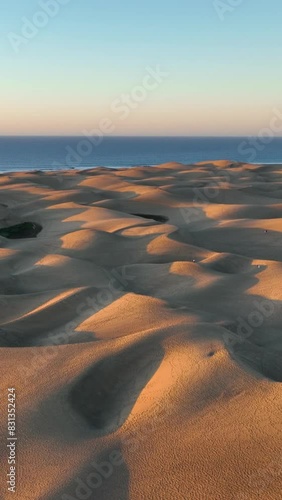 Top view of Maspalomas sand dunes. Aerial view of Gran Canaria Island. Ocean meets sand dunes. Canary islands, Spain photo