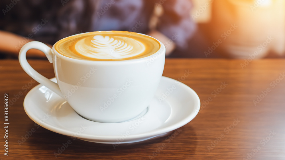 Fototapeta premium Hot coffee latte in cup mug on the table in cafe coffee shop