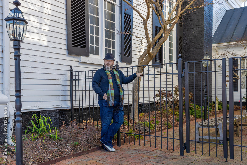 Man stands near a garden gate in downtown Greenville, Tennessee, USA Man stands near a garden gate in downtown Greenville, Tennessee, USA