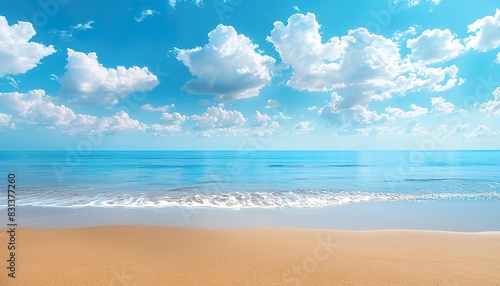 Golden sand and blue sky with white clouds on a hot summer sunny day at an empty natural beach background, pristine beach scenery, idyllic coastal view, serene seaside landscape