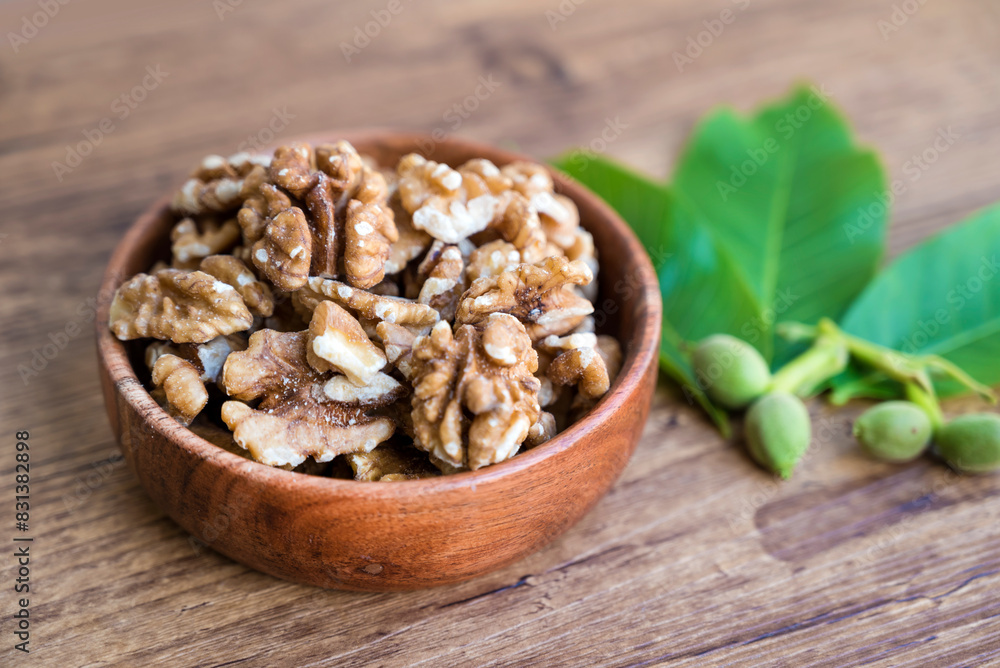 Fototapeta premium Raw Walnuts in a wooden bowl