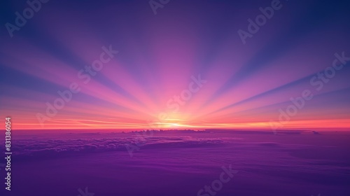 View of the sky at dawn, featuring a smooth gradient from deep purple to soft pink