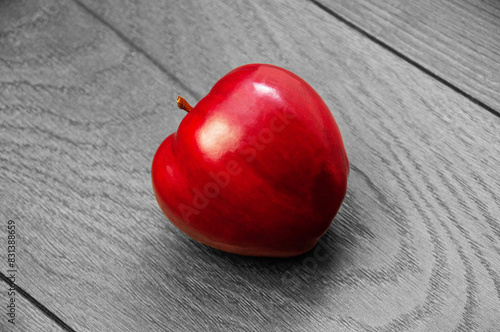 red ripe apple on a dark wooden background.	