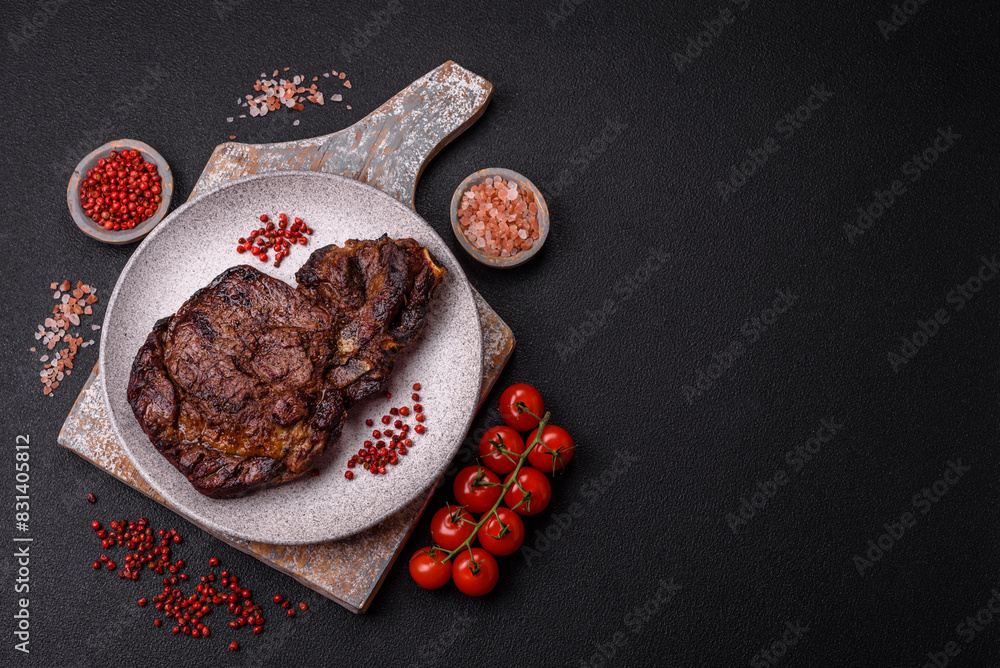 Delicious juicy beef ribeye steak grilled with salt, spices and herbs Delicious juicy beef ribeye steak grilled with salt, spices and herbs