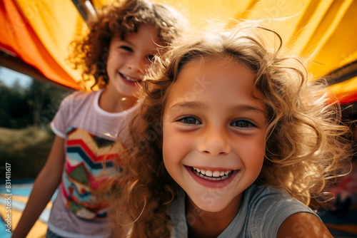 Happy smiling kids taking selfies portrait on sunny summer day