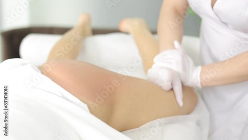 Beauty treatment. Masseuse makes by hands lymphatic drainage anti cellulite massage of legs and buttocks of female client in spa salon. Skin rejuvenation. Problem areas slimming. Wellness body