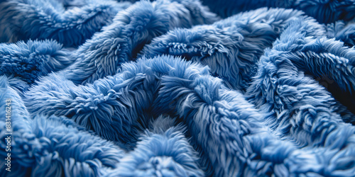 a close-up of a blue shaggy rug rug has a texture that looks like animal fur, with loops and curls in the weave color of the rug is a rich, dark blue, and it covers the entire image