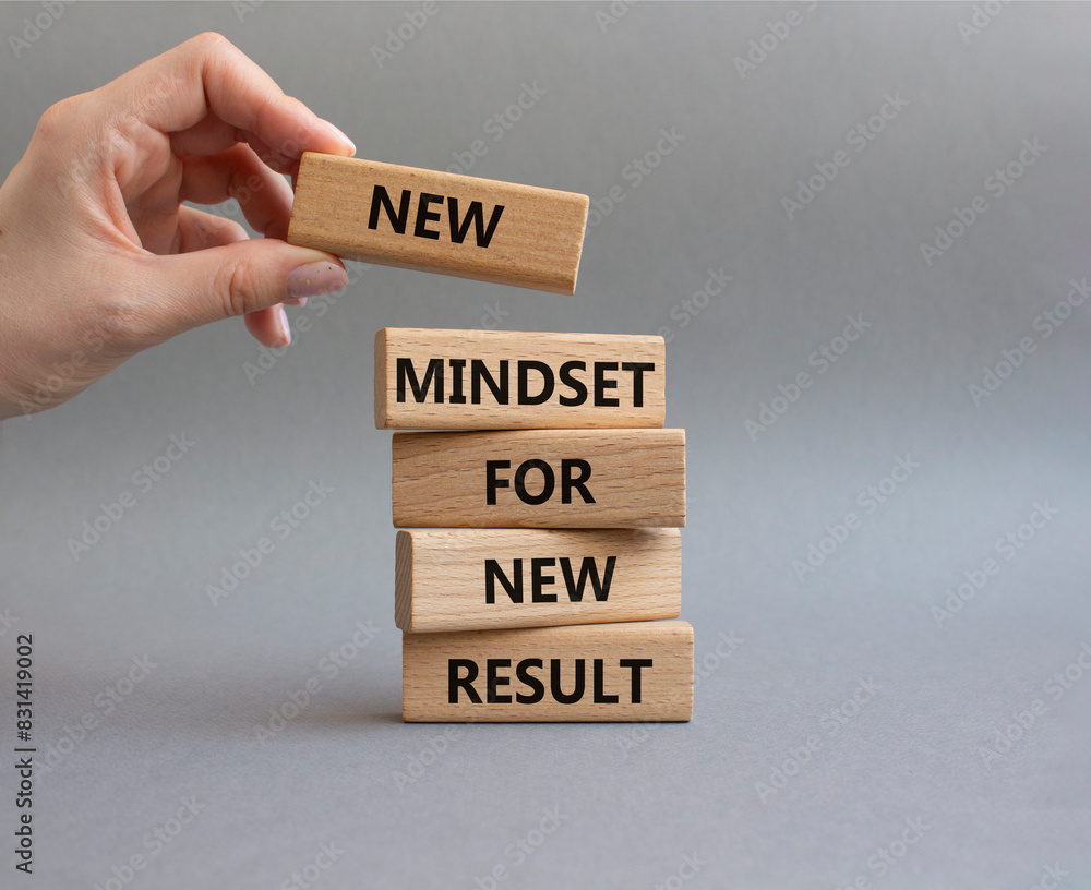 Mindset symbol. Wooden blocks with words New Mindset new Result. Businessman hand. Beautiful grey background. Business and New Mindset new Result concept. Copy space. Mindset symbol. Wooden blocks with words New Mindset new Result. Businessman hand. Beautiful grey background. Business and New Mindset new Result concept. Copy space.