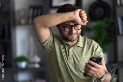 Man sitting alone at home looking sad and distraught