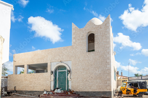 White mosque on the street of Tajoura with goats at the entrance, Tajourah region, Djibouti, Horn of Africa photo