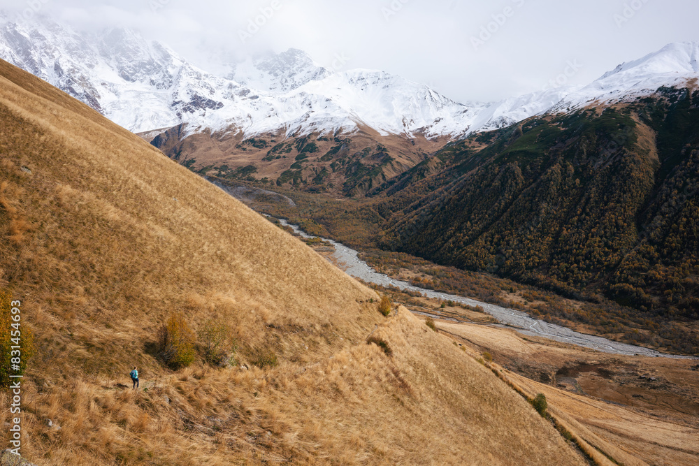 The Contrast of Golden Hills and Verdant Valleys Under the Snowy Peaks of the Caucasus The Contrast of Golden Hills and Verdant Valleys Under the Snowy Peaks of the Caucasus