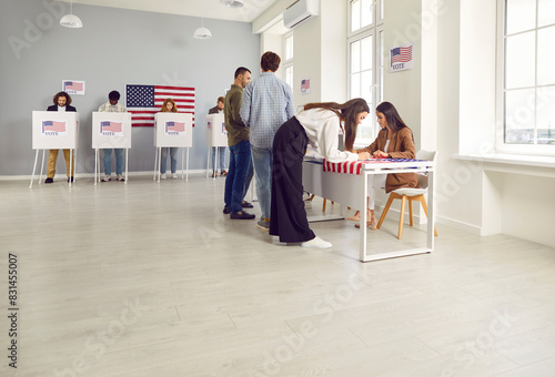 Fotografija Side view portrait of young girl american citizen registering at polling station with American flags on election day