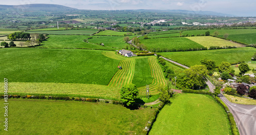 Aerial view of a green Tractor cutting Grass for Silage photo
