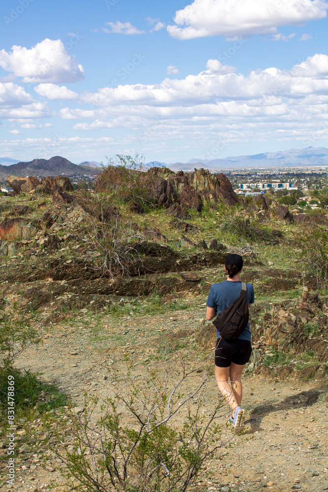 Fototapeta premium Woman taking a short hike on a mountain at Phoenix Mountain Preserve