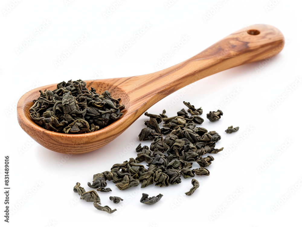 Tea leaves lie beautifully in a wooden spoon on a white background Tea leaves lie beautifully in a wooden spoon on a white background