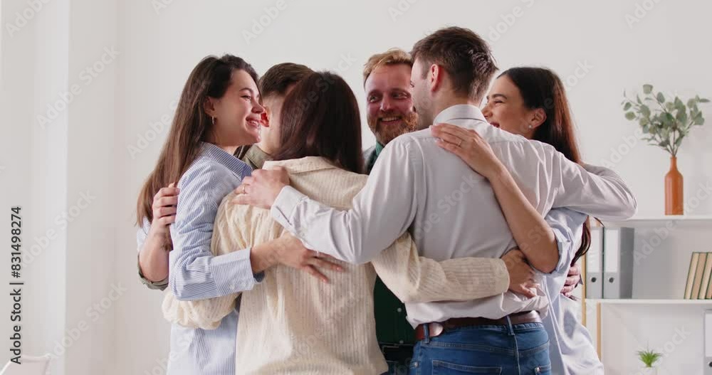 Happy and diverse business team embracing together, supporting each other in an office. Strong community, partnership, relationship, unity, and mutual support within the work group. Happy and diverse business team embracing together, supporting each other in an office. Strong community, partnership, relationship, unity, and mutual support within the work group.
