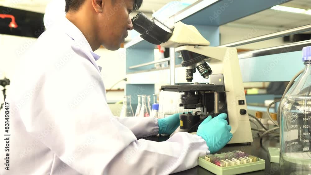 Scientist using microscope in lab,conducting research,analyzing data for industrial applications,advancing technology,contributing to innovation Scientist using microscope in lab,conducting research,analyzing data for industrial applications,advancing technology,contributing to innovation