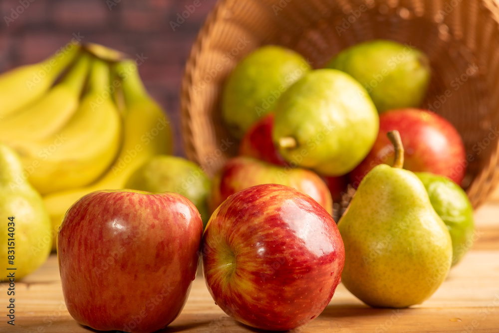 Basket with fruits on rustic wooden surface and dark background, selective focus. Basket with fruits on rustic wooden surface and dark background, selective focus.