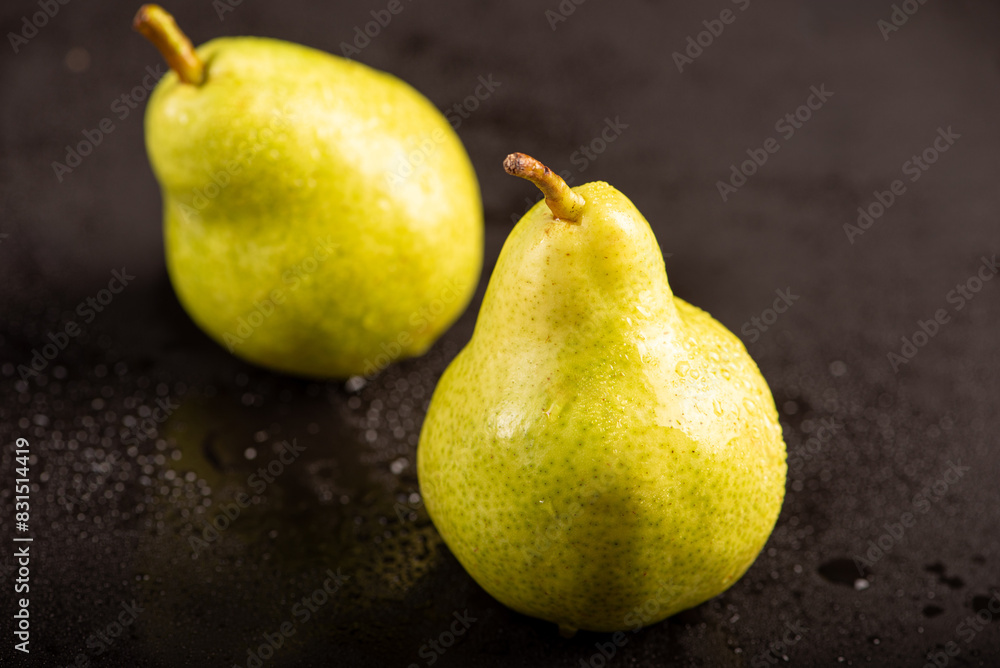 Beautiful pears placed on dark reflective surface, selective focus. Beautiful pears placed on dark reflective surface, selective focus.