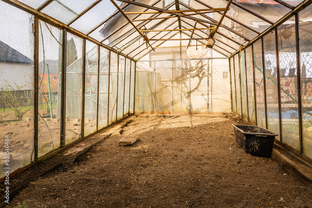 Inside of empty greenhouse, preparing soil in hothouse for sowing Inside of empty greenhouse, preparing soil in hothouse for sowing