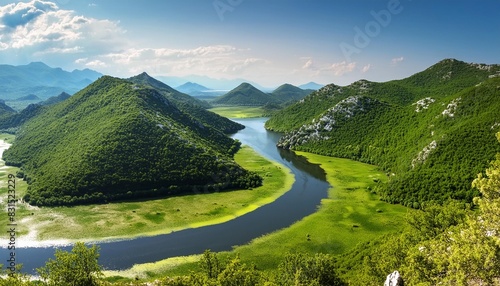 meandering rijeka crnojevica river behind green mountains amd hills in skadar lake national park montenegro natural summer landscape background photo
