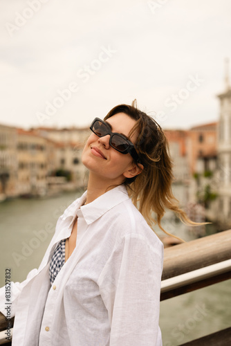 Close up photo of young happy beautiful woman in front of the venice canal. Travel concept.