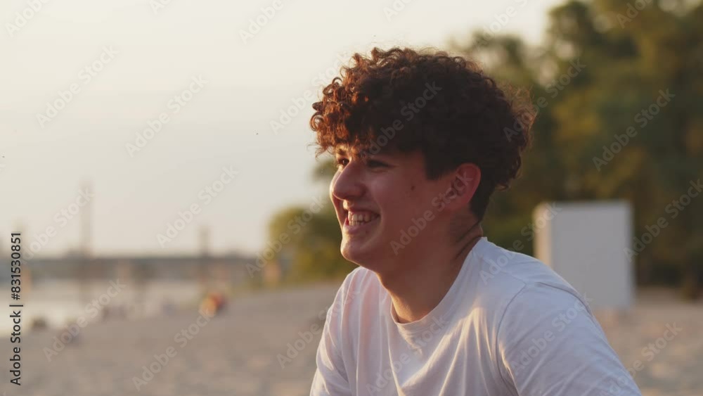 Two guys having discuss about girls on a beach. Intellect battle between best friends outdoors. Curly haired students talking at the beach. Telling humorous stories and jokes Two guys having discuss about girls on a beach. Intellect battle between best friends outdoors. Curly haired students talking at the beach. Telling humorous stories and jokes