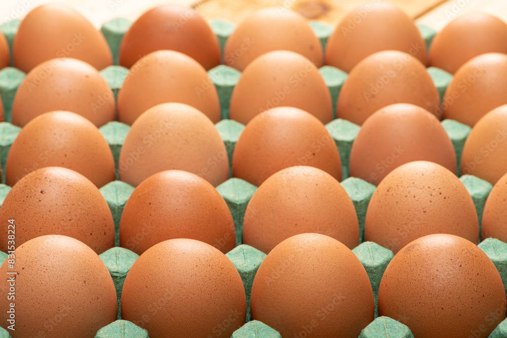 Red eggs placed on a cardboard carton for sale, on rustic wood, selective focus. Red eggs placed on a cardboard carton for sale, on rustic wood, selective focus.