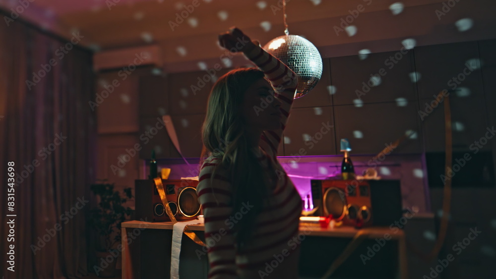 Obraz premium Closed eyes woman dancing in apartment after night party disco ball close up.