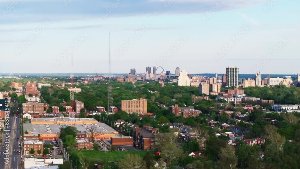 Reveal shot of St. Louis cityscape from above, highlighting its urban architecture, green spaces, and iconic landmarks Reveal shot of St. Louis cityscape from above, highlighting its urban architecture, green spaces, and iconic landmarks