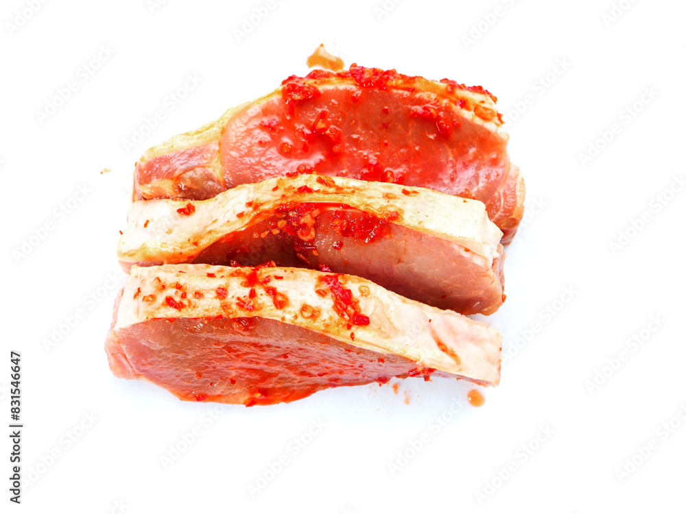 Pork chops in red Asian style marinade with chilly pepper. Fine pork meat for grill or summer barbecue. Popular dish with rich flavor. White background.
