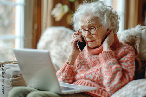 Elderly Woman Using Laptop and Talking on Phone